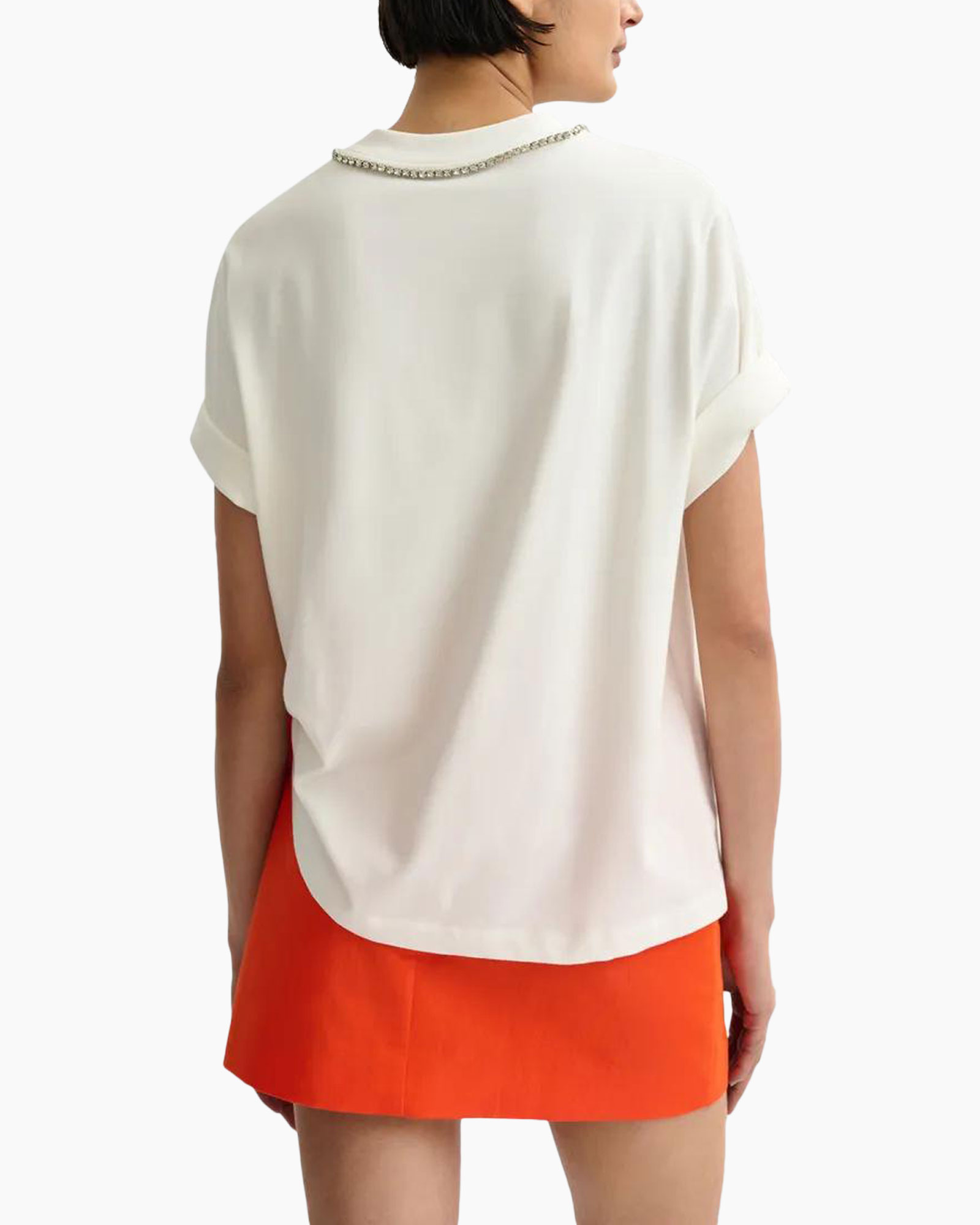 tshirt, graphic tee, linen? no (fabric not clear), orange skirt, bow detail, asymmetrical hem, shorts? wait it's a mini skirt