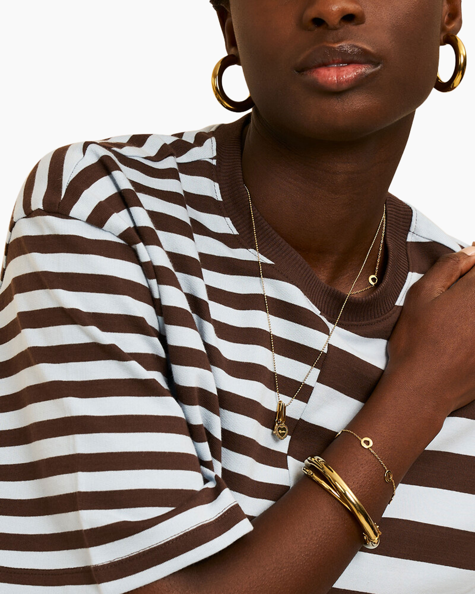 striped shirt, brown white, gold jewelry, hoop earrings, bracelet