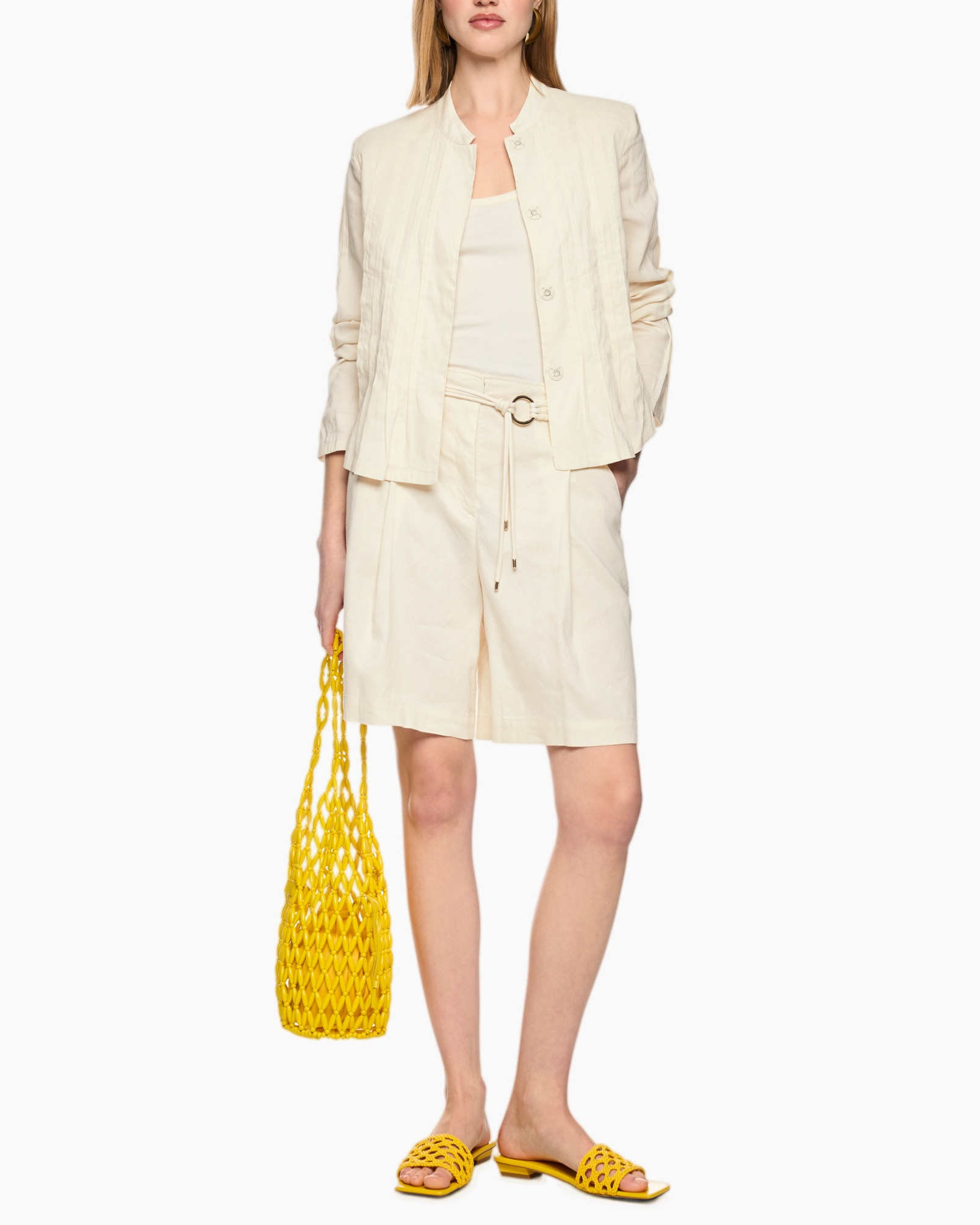 beige outfit, linen shorts, matching jacket, yellow accessories, netted sandals