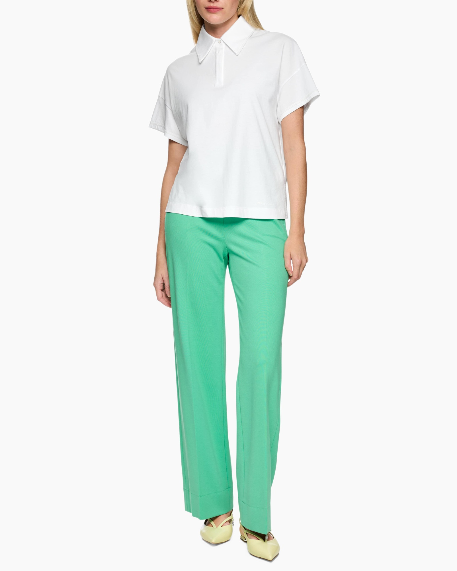white polo, short sleeves, collared top, green pants, flat shoes