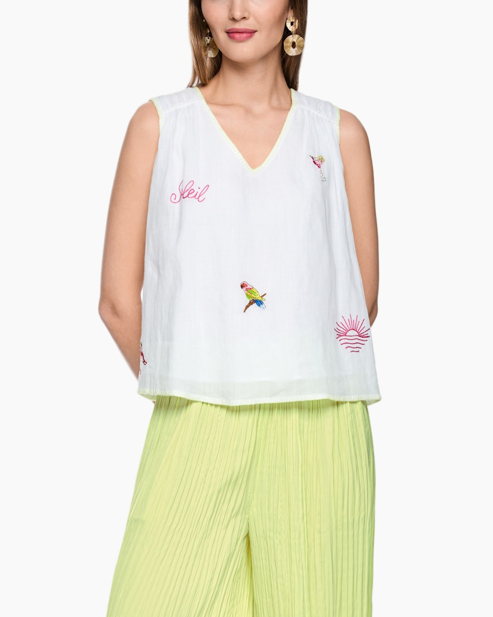 witte mouwloze top, borduring/borduren?, vogelprint, V-hals, limegroene broek