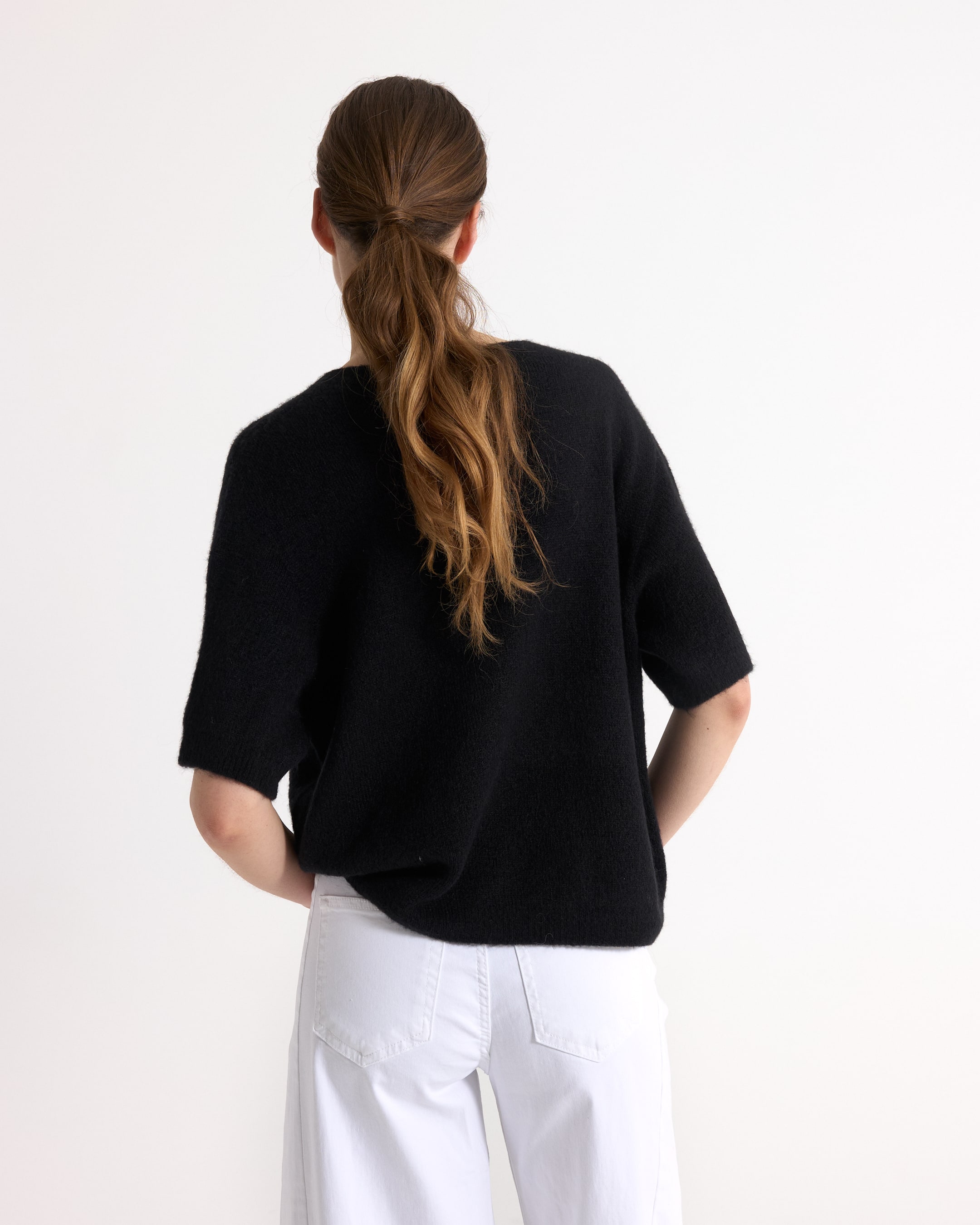 black top, short sleeve, knit sweater, solid color, back view