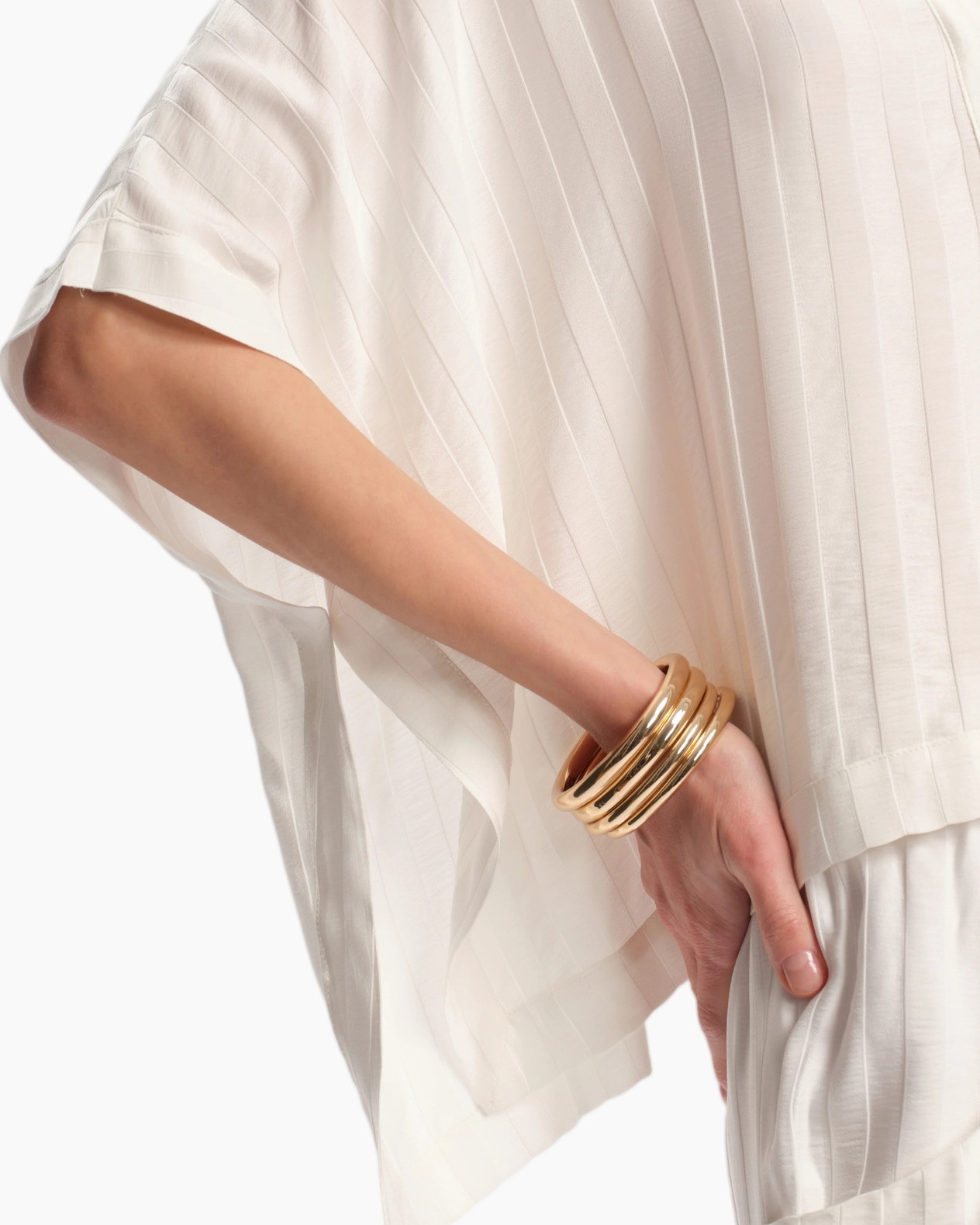 white blouse, pleated fabric, bolero sleeve, gold bangle, fashion accessory