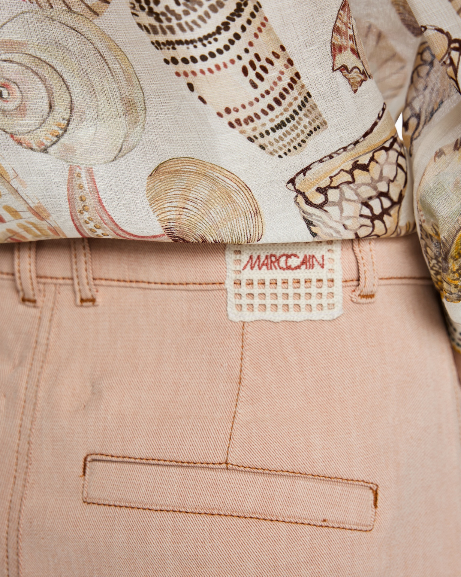 peach pants, back pocket, belt loop, tag label, textile pattern