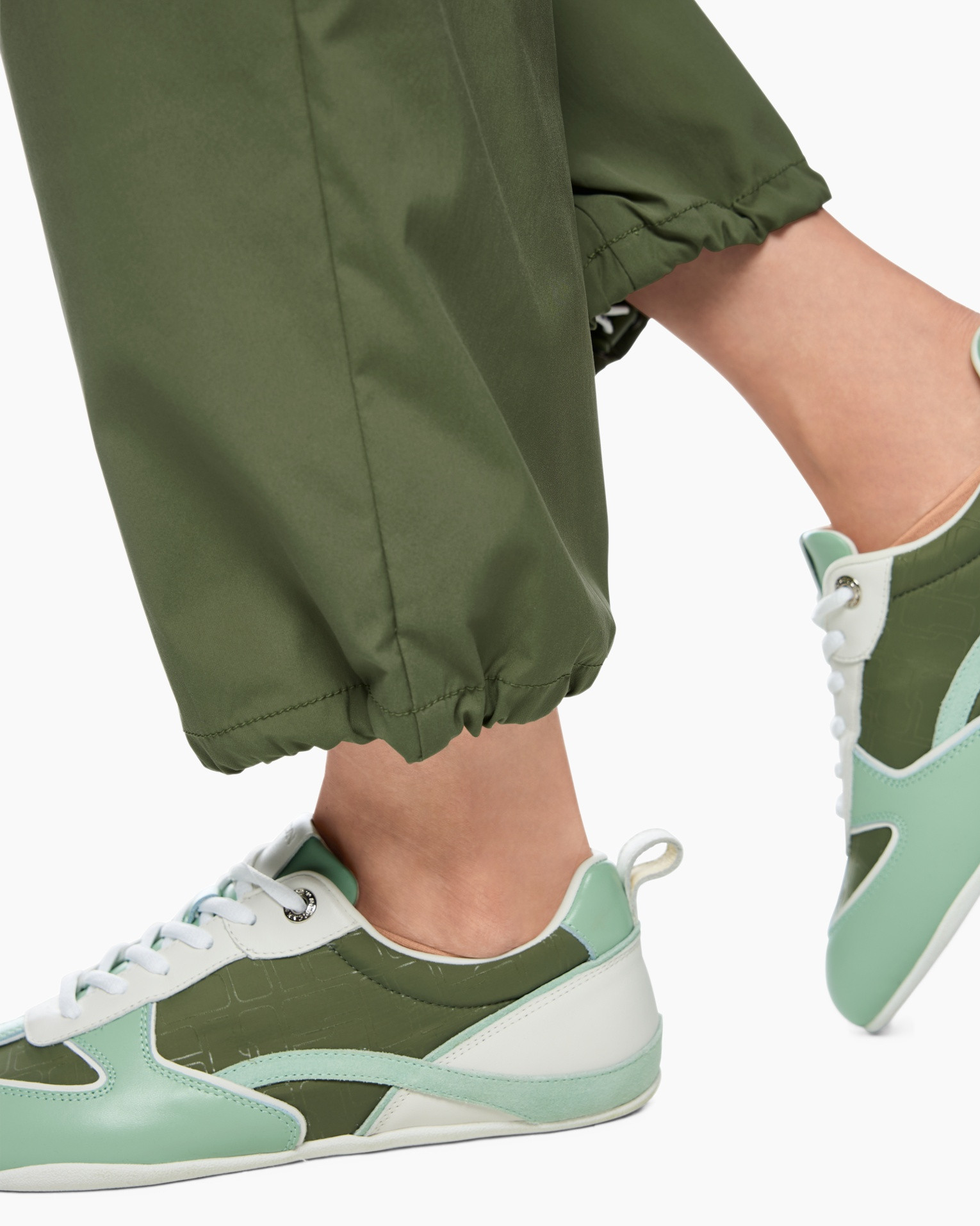 green pants, ankle cuffs, sneakers, green white sneakers, sporty shoes