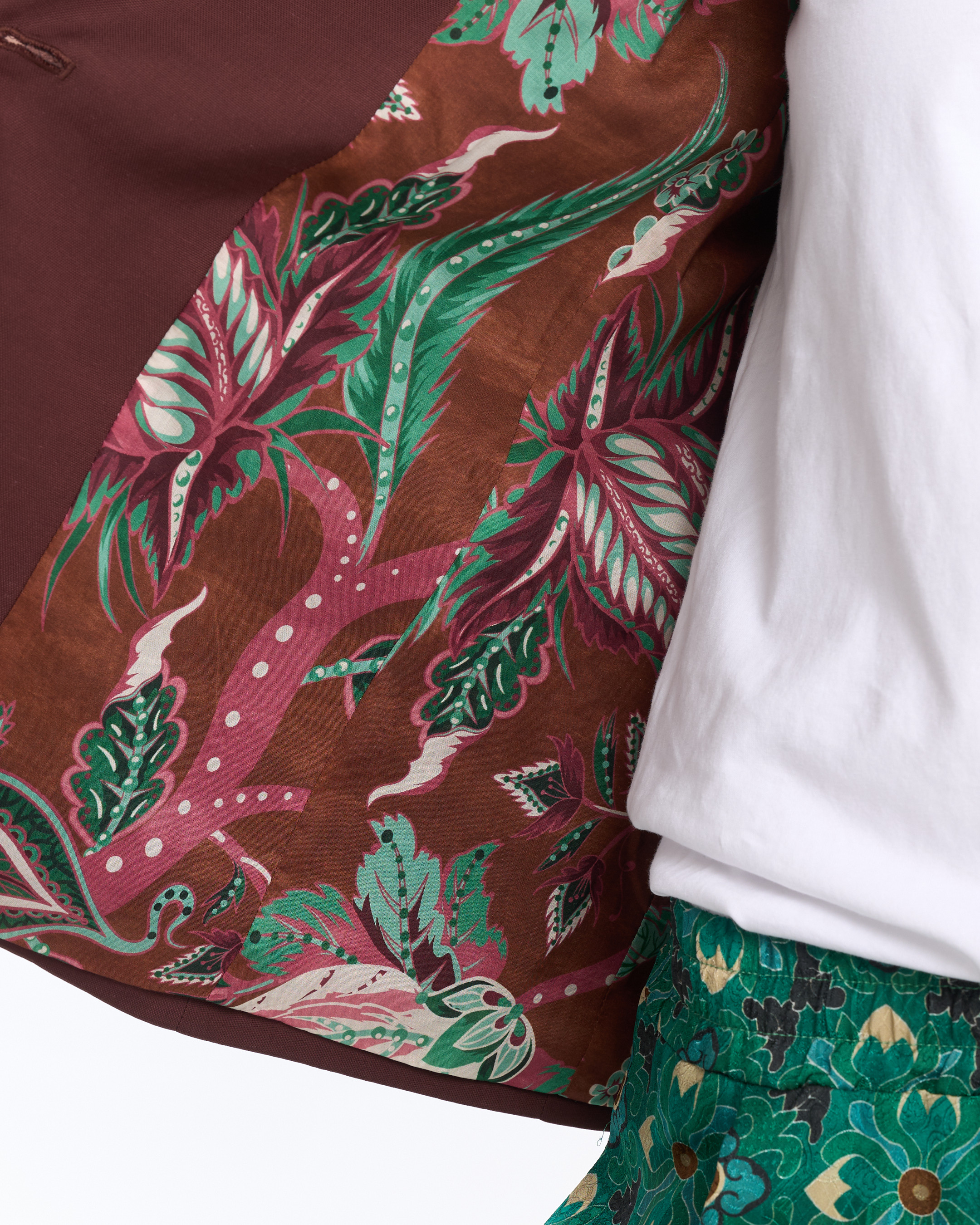 patterned fabric, floral print, brown fabric, green leaves, white shirt